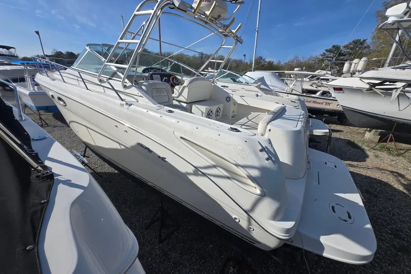 The Image of 2000 Sea Ray 290 Amberjack boat on display in a marina under clear blue skies. - 0