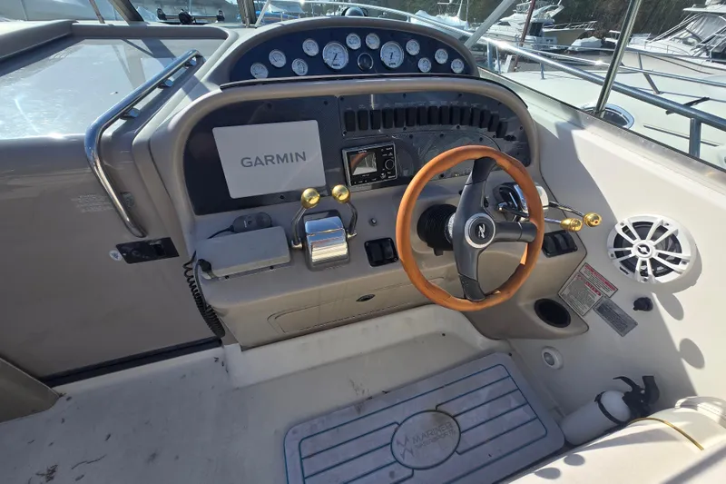 Slide: The Image of Cockpit of 2000 Sea Ray 290 Amberjack with Garmin navigation and wooden steering wheel. - 10