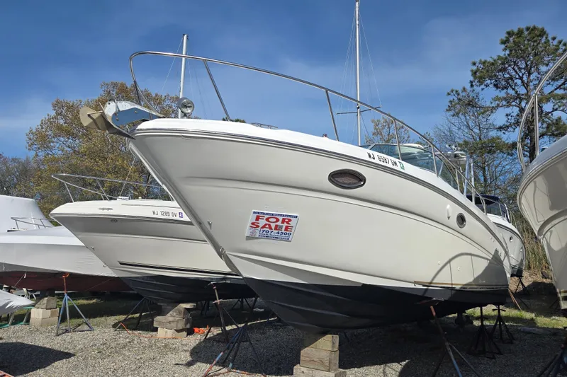 Slide: The Image of 2000 Sea Ray 290 Amberjack boat for sale, displayed on stands outdoors. - 12