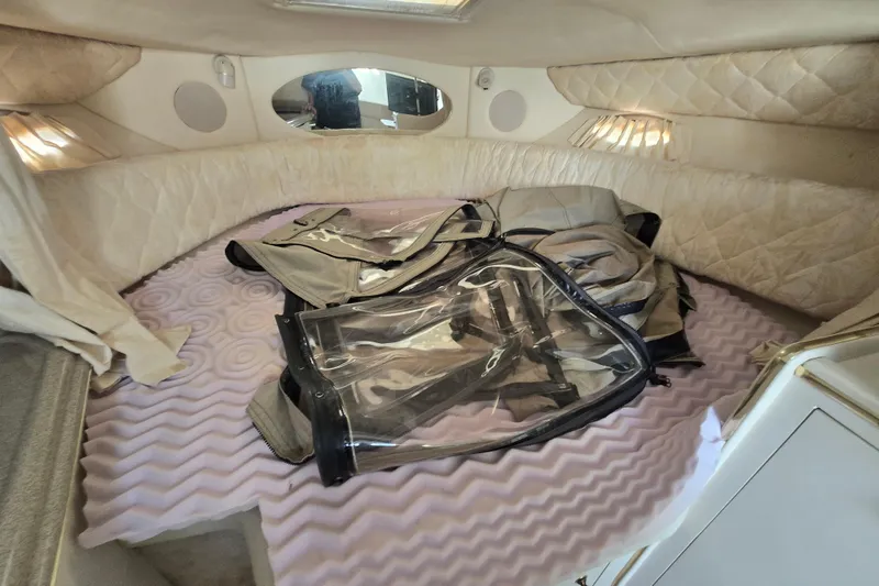 Slide: The Image of Interior cabin of 2000 Sea Ray 290 Amberjack with bedding and storage items. - 13