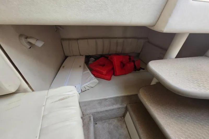 Slide: The Image of Interior cabin of 2000 Sea Ray 290 Amberjack with life jackets and seating. - 16