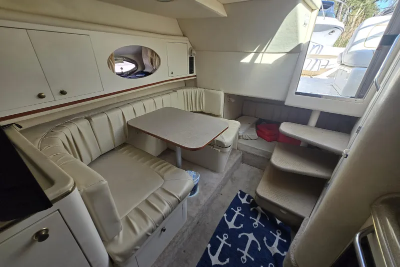 Slide: The Image of Interior of 2000 Sea Ray 290 Amberjack with seating, table, and nautical decor. - 18