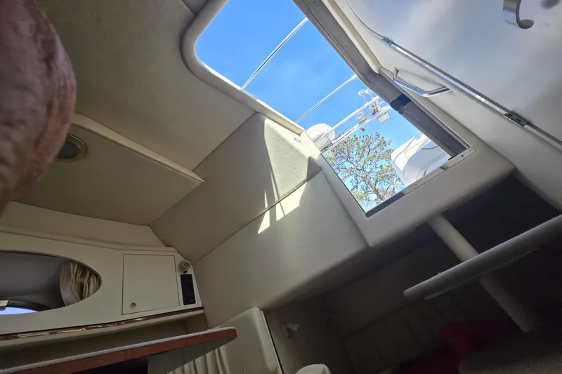 Slide: The Image of Interior cabin view of a 2000 Sea Ray 290 Amberjack boat with open hatch. - 19
