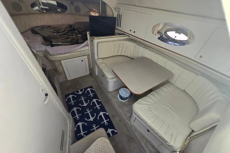 Slide: The Image of Interior of 2000 Sea Ray 290 Amberjack with cozy seating and dining area. - 2