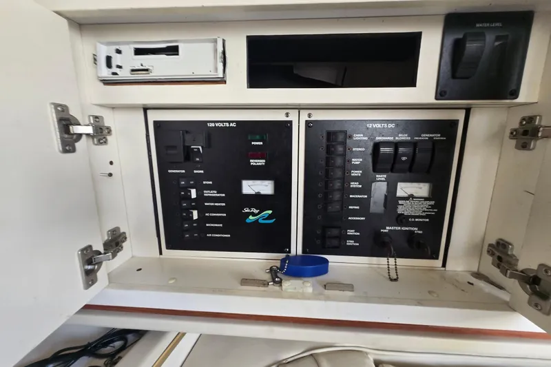 Slide: The Image of Electrical control panel of a 2000 Sea Ray 290 Amberjack boat, featuring AC and DC switches. - 20