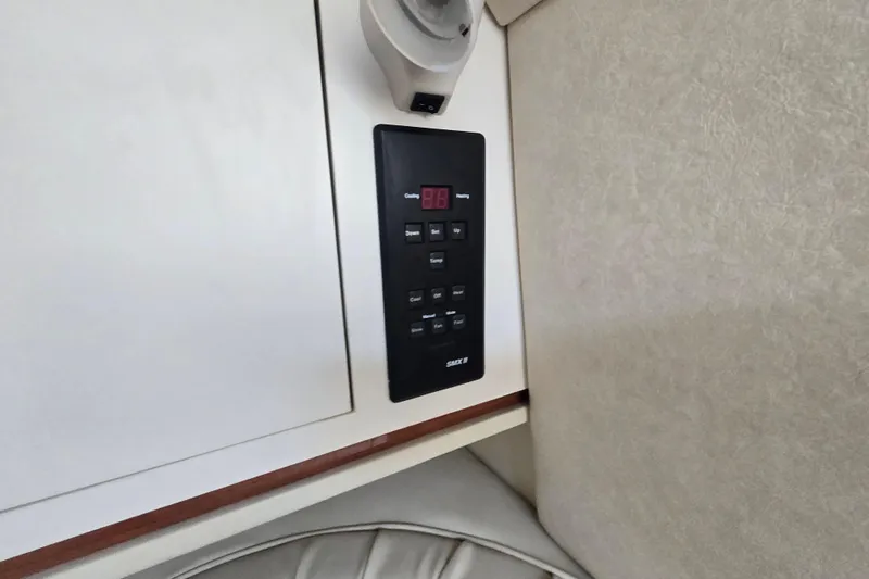 Slide: The Image of Control panel inside 2000 Sea Ray 290 Amberjack boat cabin, featuring digital display and buttons. - 21