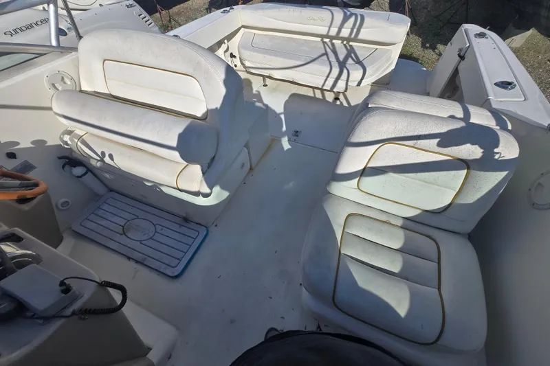 Slide: The Image of 2000 Sea Ray 290 Amberjack boat interior with white cushioned seating. - 24