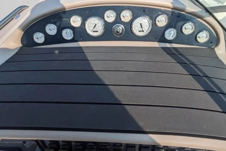 Slide: The Image of Dashboard of a 2000 Sea Ray 290 Amberjack boat with multiple gauges. - 34