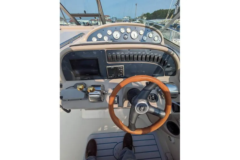 Slide: The Image of Steering console of a 2000 Sea Ray 290 Amberjack boat with gauges and controls. - 36