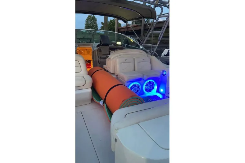 Slide: The Image of 2000 Sea Ray 290 Amberjack boat interior with blue LED lights and seating area. - 37
