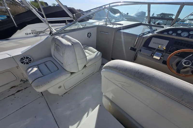Slide: The Image of 2000 Sea Ray 290 Amberjack cockpit with Garmin navigation and white seating. - 8