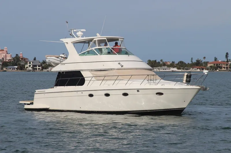 Slide: The Image of 2005 Carver 46 Voyager yacht on calm waters. - 13