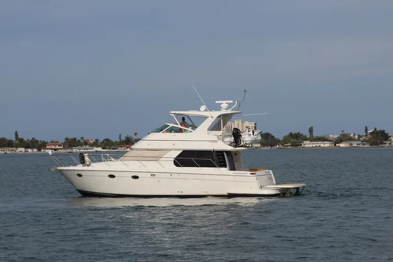 Slide: The Image of 2005 Carver 46 Voyager yacht on calm waters. - 15