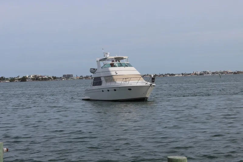 Slide: The Image of 2005 Carver 46 Voyager yacht on calm waters. - 16