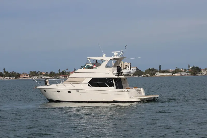 Slide: The Image of 2005 Carver 46 Voyager yacht on calm waters. - 17