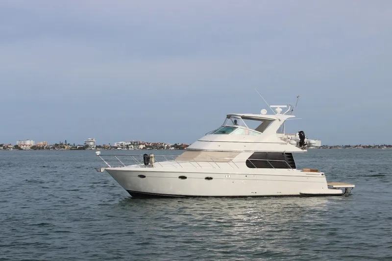 Slide: The Image of 2005 Carver 46 Voyager yacht on calm waters. - 19