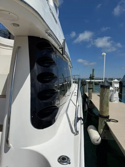 Slide: The Image of 2005 Carver 46 Voyager yacht docked on a sunny day. - 27