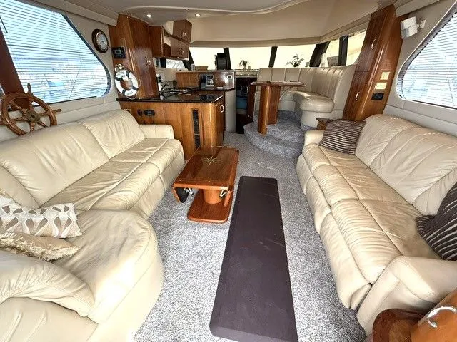 Slide: The Image of Interior of Carver 46 Voyager yacht, luxurious living area with leather sofas, 2005 model. - 42
