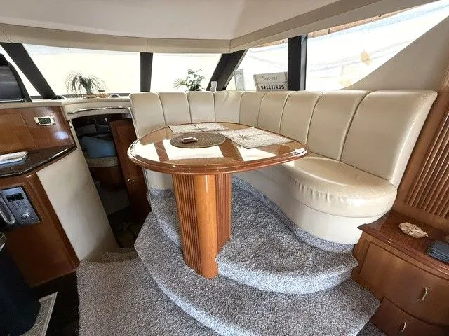 Slide: The Image of Interior of 2005 Carver 46 Voyager yacht with elegant seating area. - 48