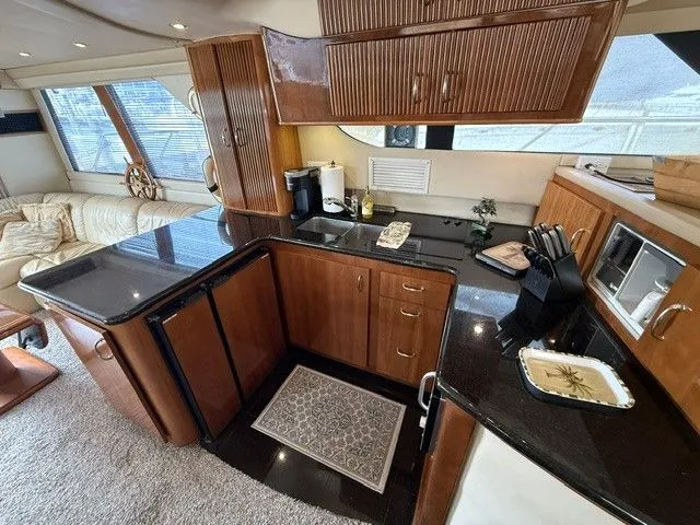 Slide: The Image of Interior of Carver 46 Voyager yacht, kitchen with wood cabinets, 2005 model. - 49