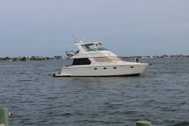 Slide: The Image of 2005 Carver 46 Voyager yacht on calm waters. - 7