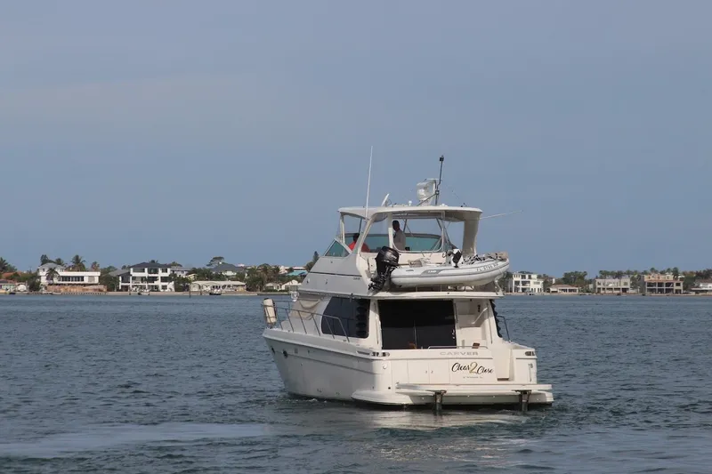 Slide: The Image of 2005 Carver 46 Voyager yacht on calm waters. - 8