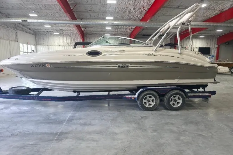 The Image of 2008 Sea Ray 240 Sundeck boat on trailer in indoor storage facility. - 1