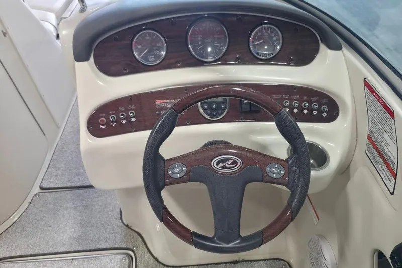 Slide: The Image of 2008 Sea Ray 240 Sundeck dashboard with steering wheel and instrument panel. - 10