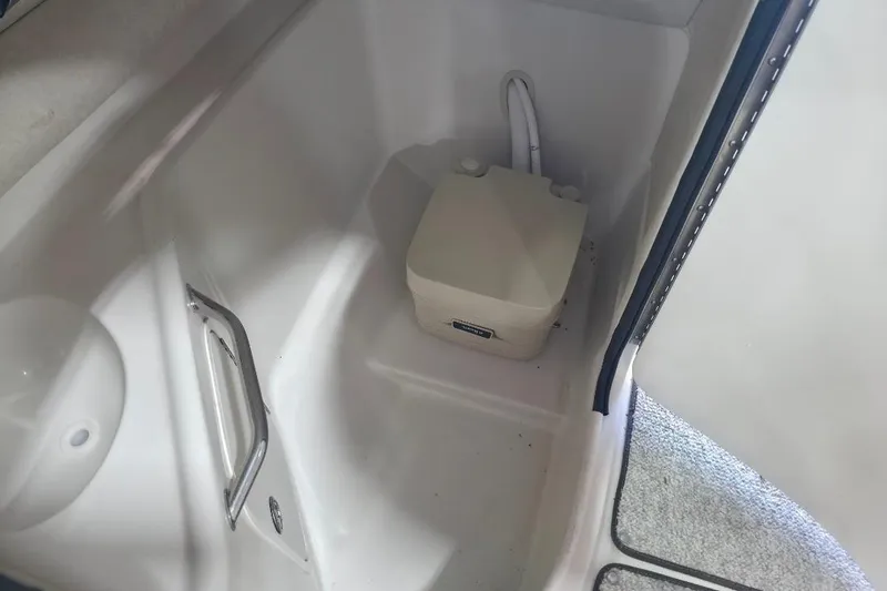 Slide: The Image of Interior of 2008 Sea Ray 240 Sundeck boat with portable toilet and handrail. - 11