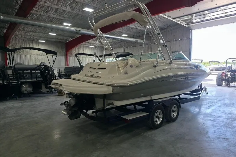 Slide: The Image of 2008 Sea Ray 240 Sundeck boat on trailer in indoor storage facility. - 3