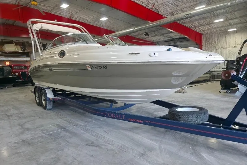 Slide: The Image of 2008 Sea Ray 240 Sundeck boat on trailer in indoor storage facility. - 5