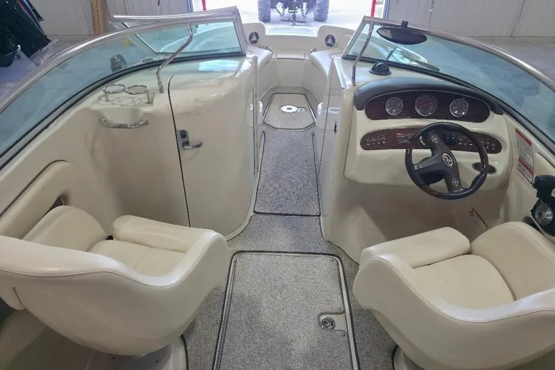 Slide: The Image of Interior view of a 2008 Sea Ray 240 Sundeck boat with beige seating and dashboard. - 7