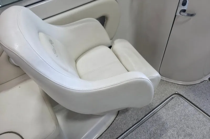 Slide: The Image of White captain's chair on 2008 Sea Ray 240 Sundeck boat, featuring plush upholstery. - 9