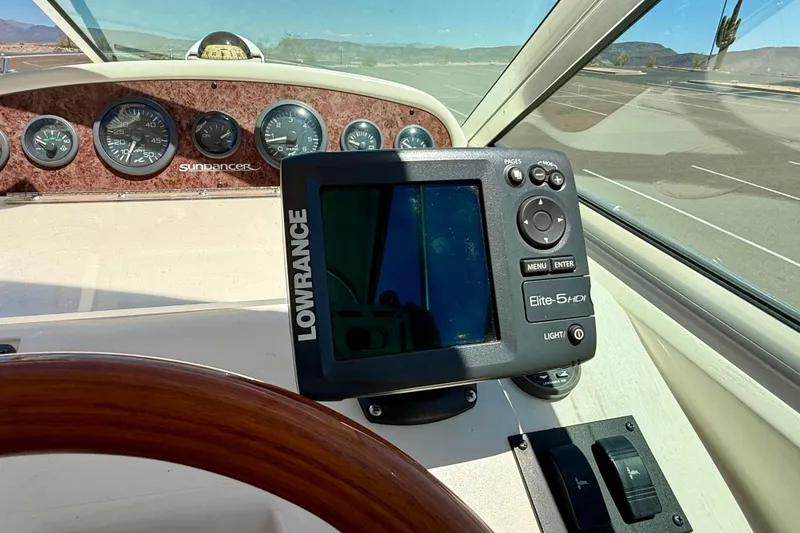 Slide: The Image of 1996 Sea Ray 250 Sundancer dashboard with Lowrance Elite-5 HDI display and gauges. - 15