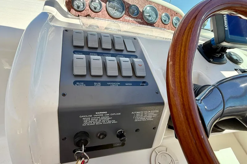 Slide: The Image of 1996 Sea Ray 250 Sundancer dashboard with control panel and wooden steering wheel. - 17