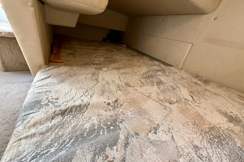 Slide: The Image of Interior cabin view of a 1996 Sea Ray 250 Sundancer boat, featuring a patterned cushion. - 23