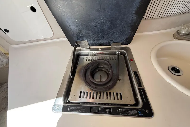 Slide: The Image of Stove and sink in 1996 Sea Ray 250 Sundancer boat kitchen area. - 31