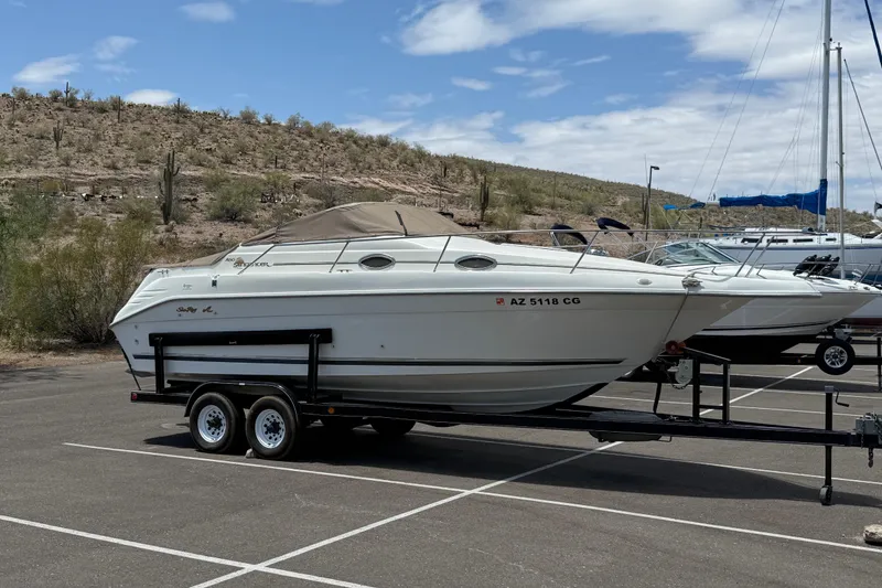 Slide: The Image of 1996 Sea Ray 250 Sundancer boat on trailer in desert parking lot. - 36