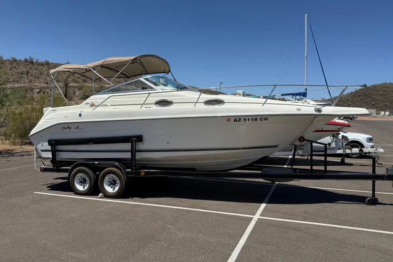 Slide: The Image of 1996 Sea Ray 250 Sundancer boat on trailer in sunny parking lot. - 4