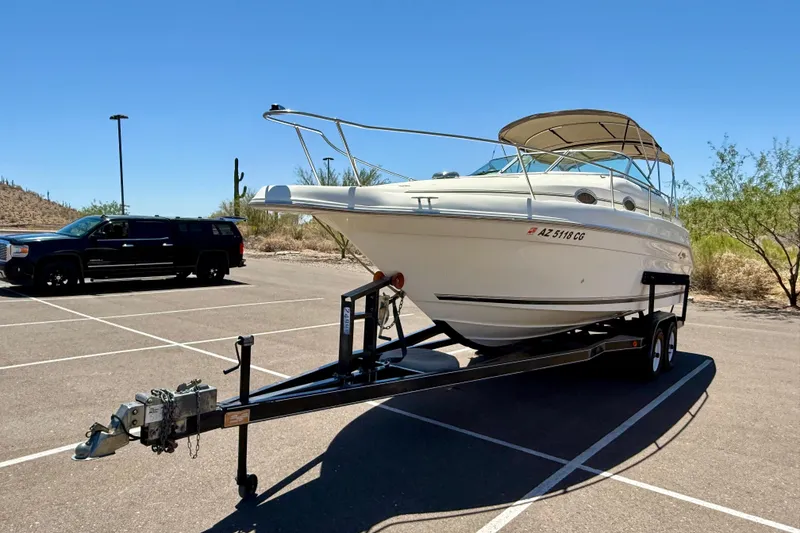 Slide: The Image of 1996 Sea Ray 250 Sundancer boat on trailer in sunny parking lot. - 5