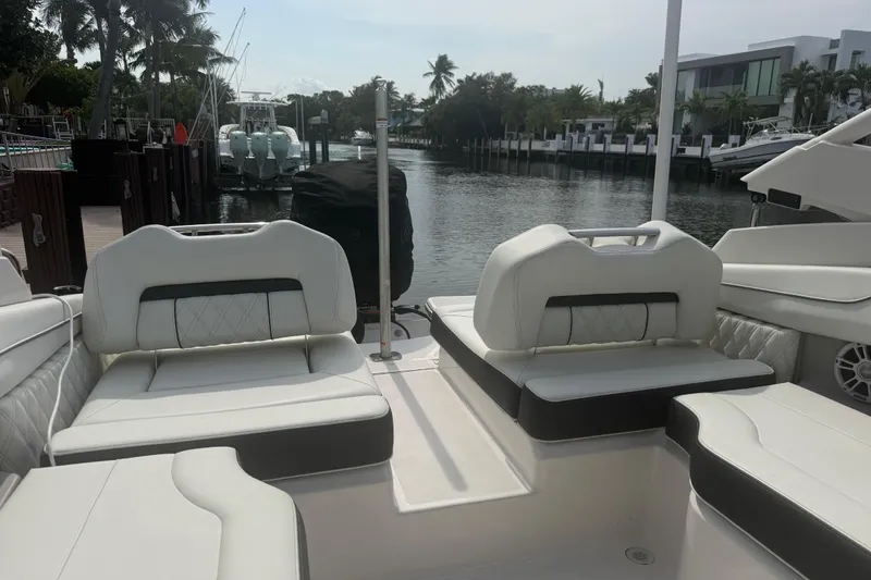 Slide: The Image of Luxurious seating on a 2024 Regal LX2 boat docked by a scenic waterfront. - 10