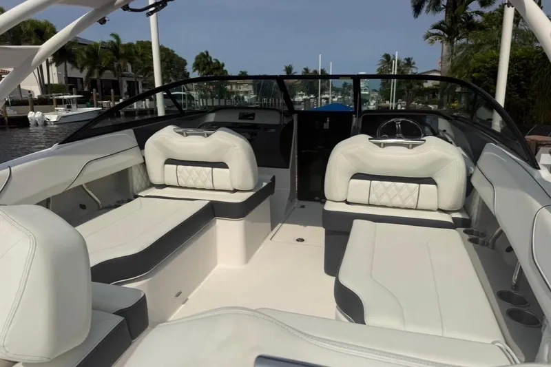 Slide: The Image of 2024 Regal LX2 boat interior with luxurious white seating and sleek design. - 13