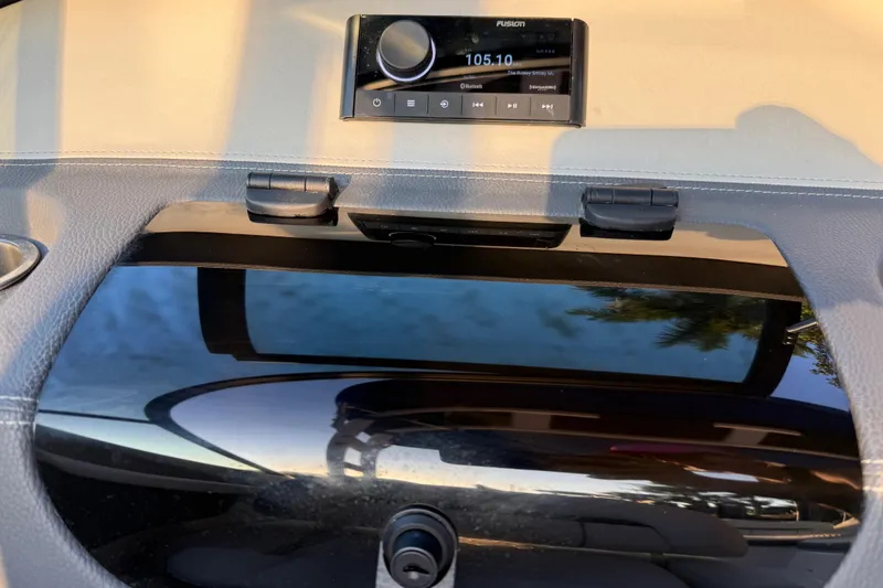 Slide: The Image of 2024 Regal LX2 dashboard with Fusion stereo system, displaying radio frequency 105.10. - 15
