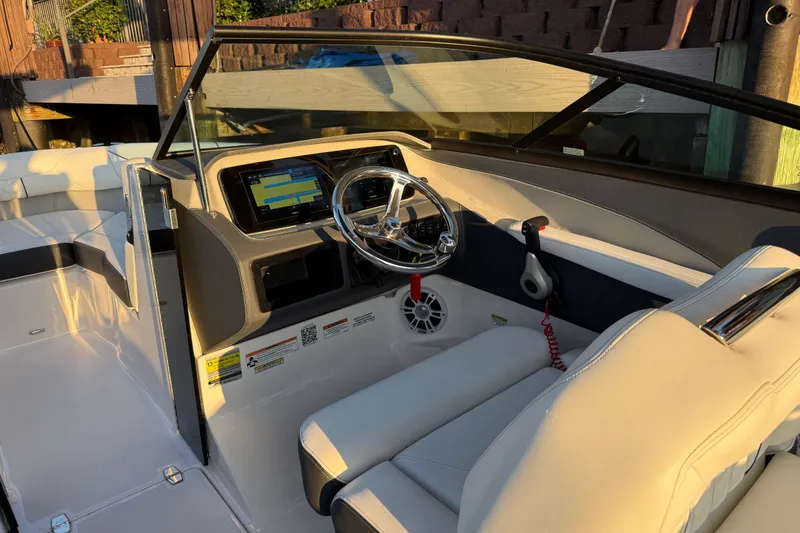 Slide: The Image of Interior of 2024 Regal LX2 boat, featuring modern dashboard and steering wheel. - 17
