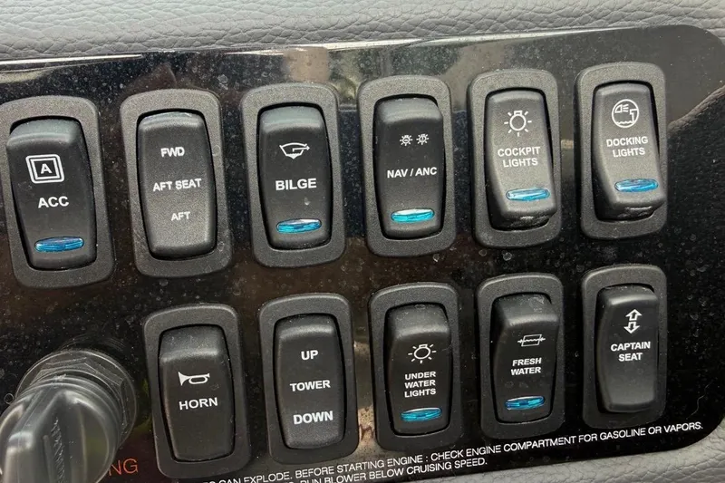 Slide: The Image of Control panel of a 2024 Regal LX2 boat with various switches. - 19