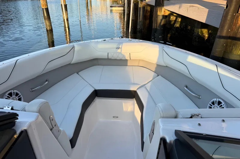 Slide: The Image of 2024 Regal LX2 boat interior with white seating and waterfront view. - 20