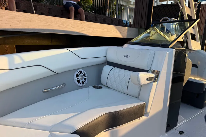 Slide: The Image of 2024 Regal LX2 boat interior with white seating and speaker detail. - 21
