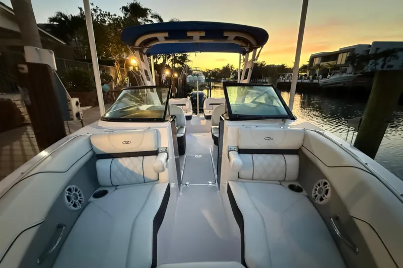 Slide: The Image of 2024 Regal LX2 boat interior at sunset, featuring luxurious seating and modern design. - 24