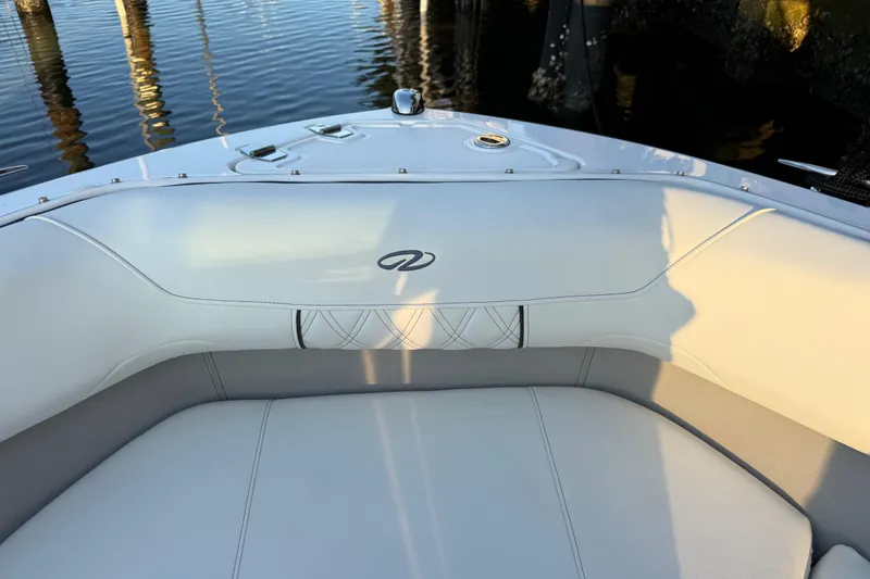 Slide: The Image of 2024 Regal LX2 boat interior with elegant white seating and water reflection. - 25