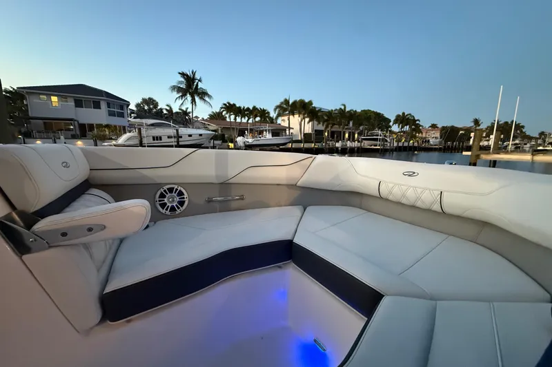 Slide: The Image of Luxurious interior of 2024 Regal LX2 boat with waterfront view at dusk. - 31